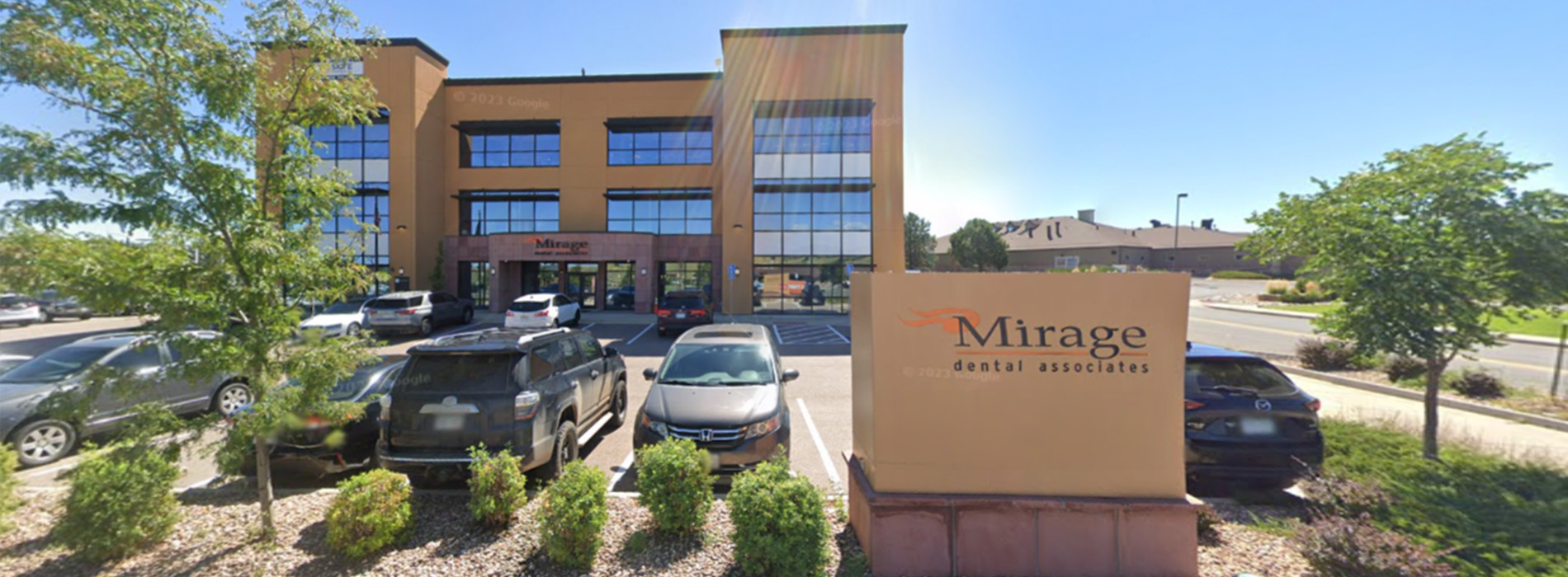 The image shows a modern dental clinic interior with various pieces of equipment, including a dental chair and an X-ray machine.